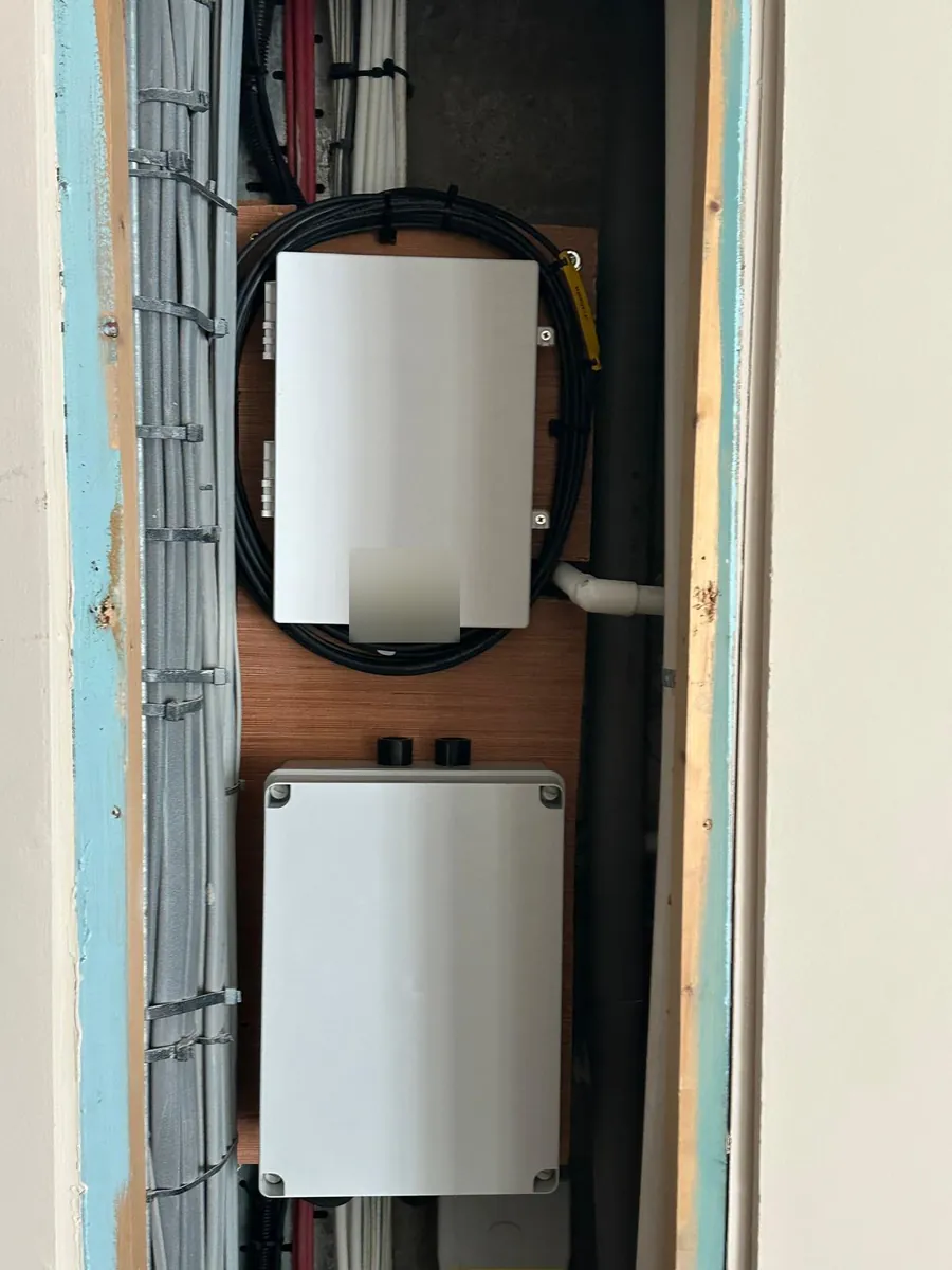 Riser backboard with fibre enclosures and neatly coiled cable