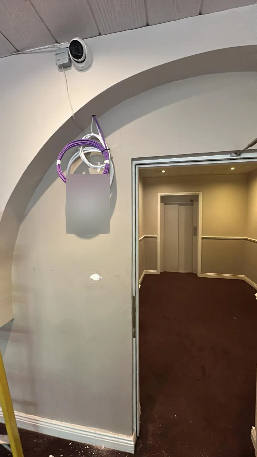 Cable drop in a common corridor, with CCTV on the arch