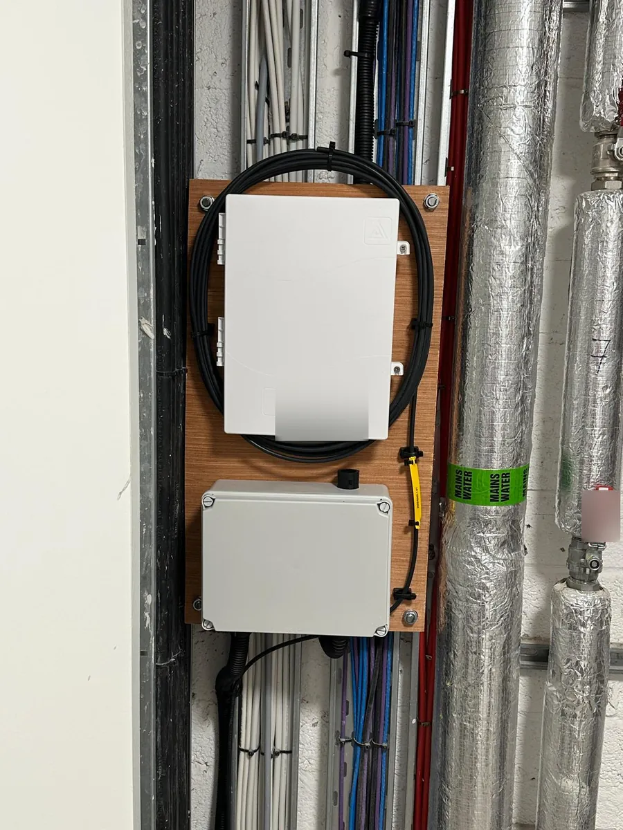 Fibre enclosures fitted alongside existing services in a riser