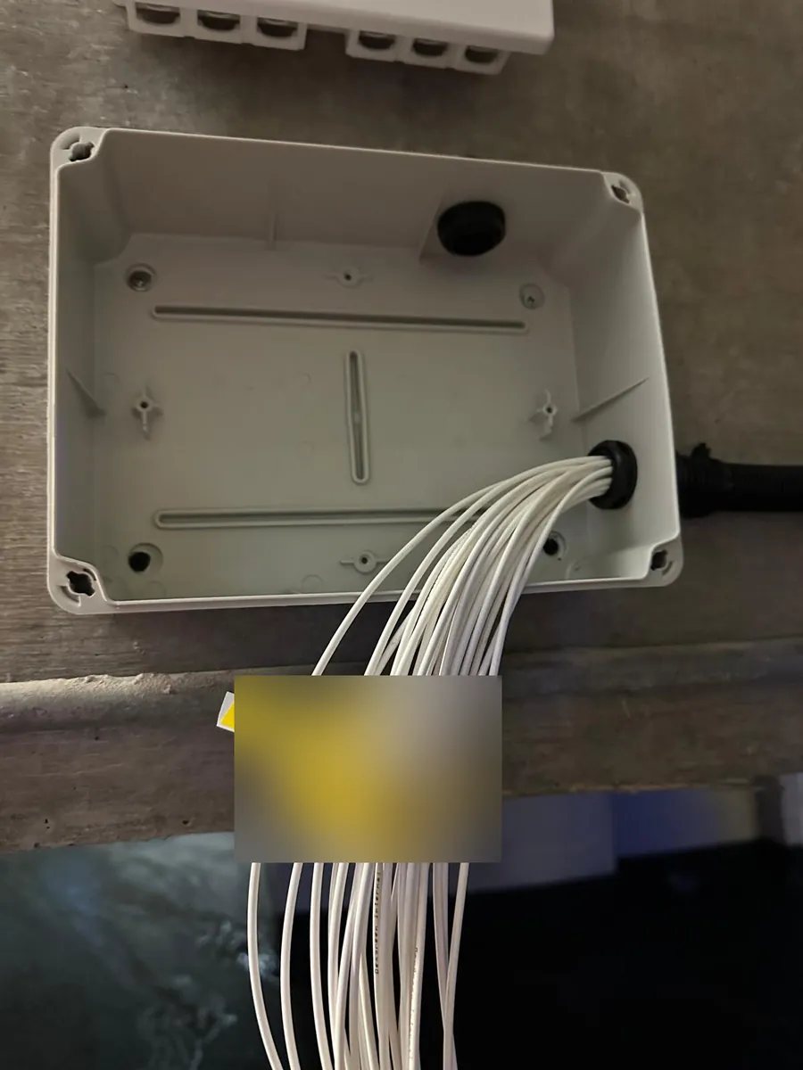 Labelled fibre drops entering a junction box