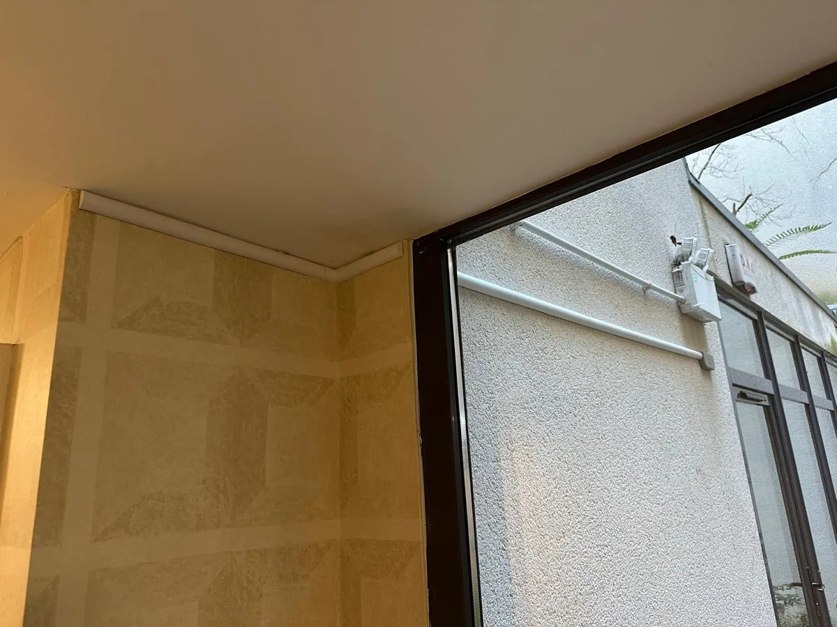 External conduit run seen through a corridor window