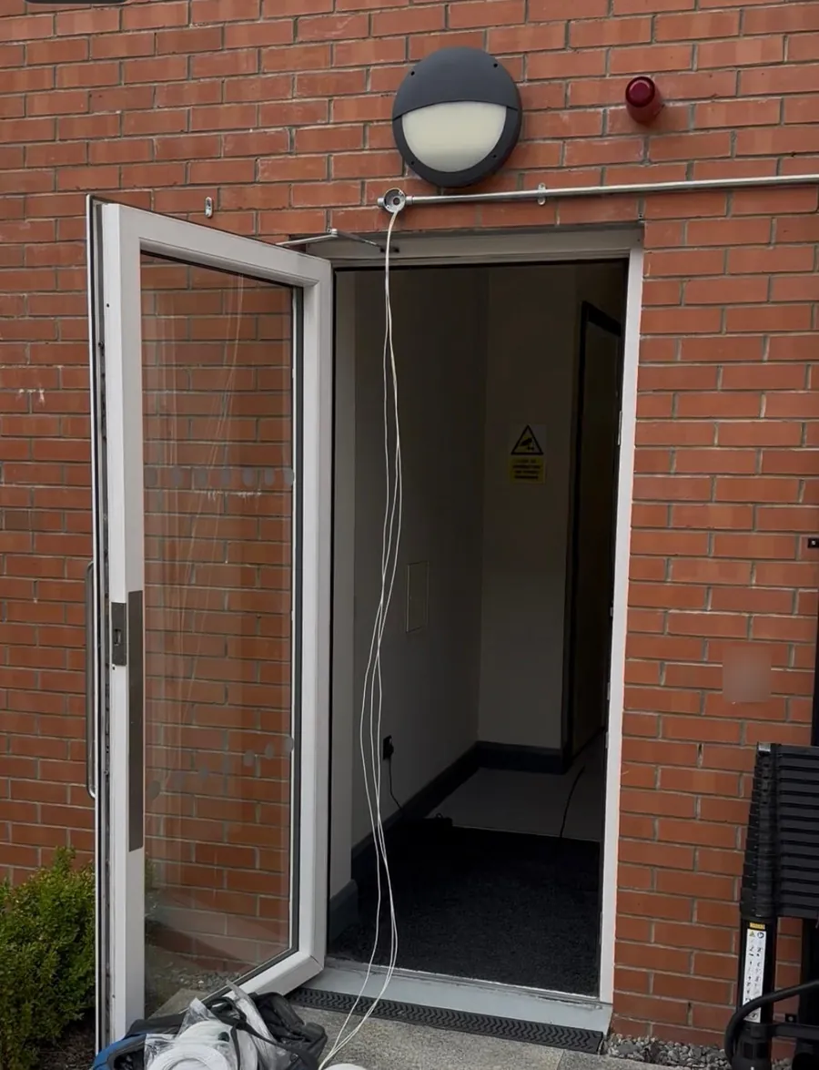 Cable brought in through conduit above an entrance door